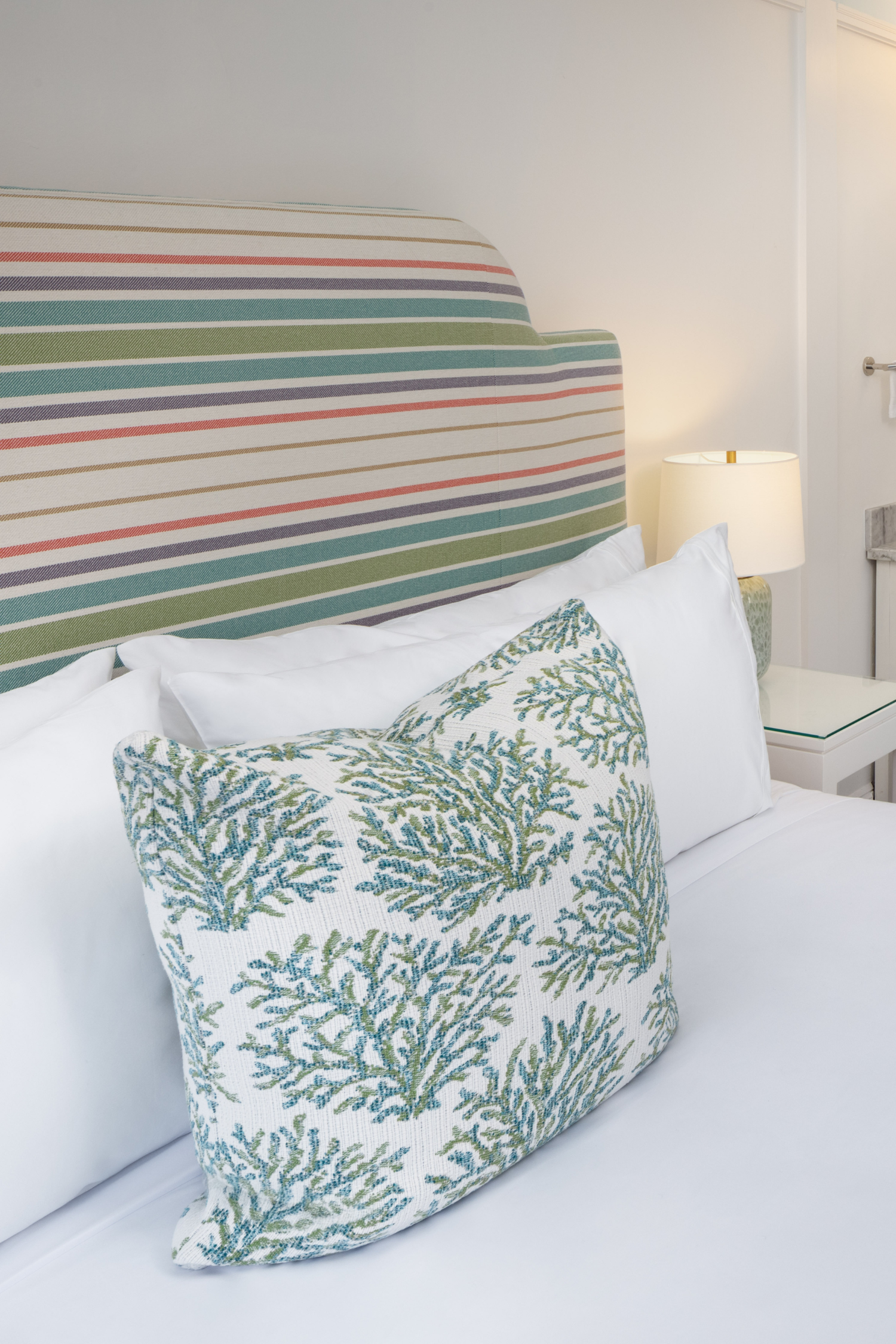 Colorful striped headboard in a Petite Queen guest room at 76 Main Ink Press Hotel
