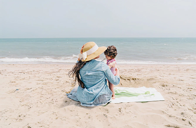 Mother and daughter enjoying the beach