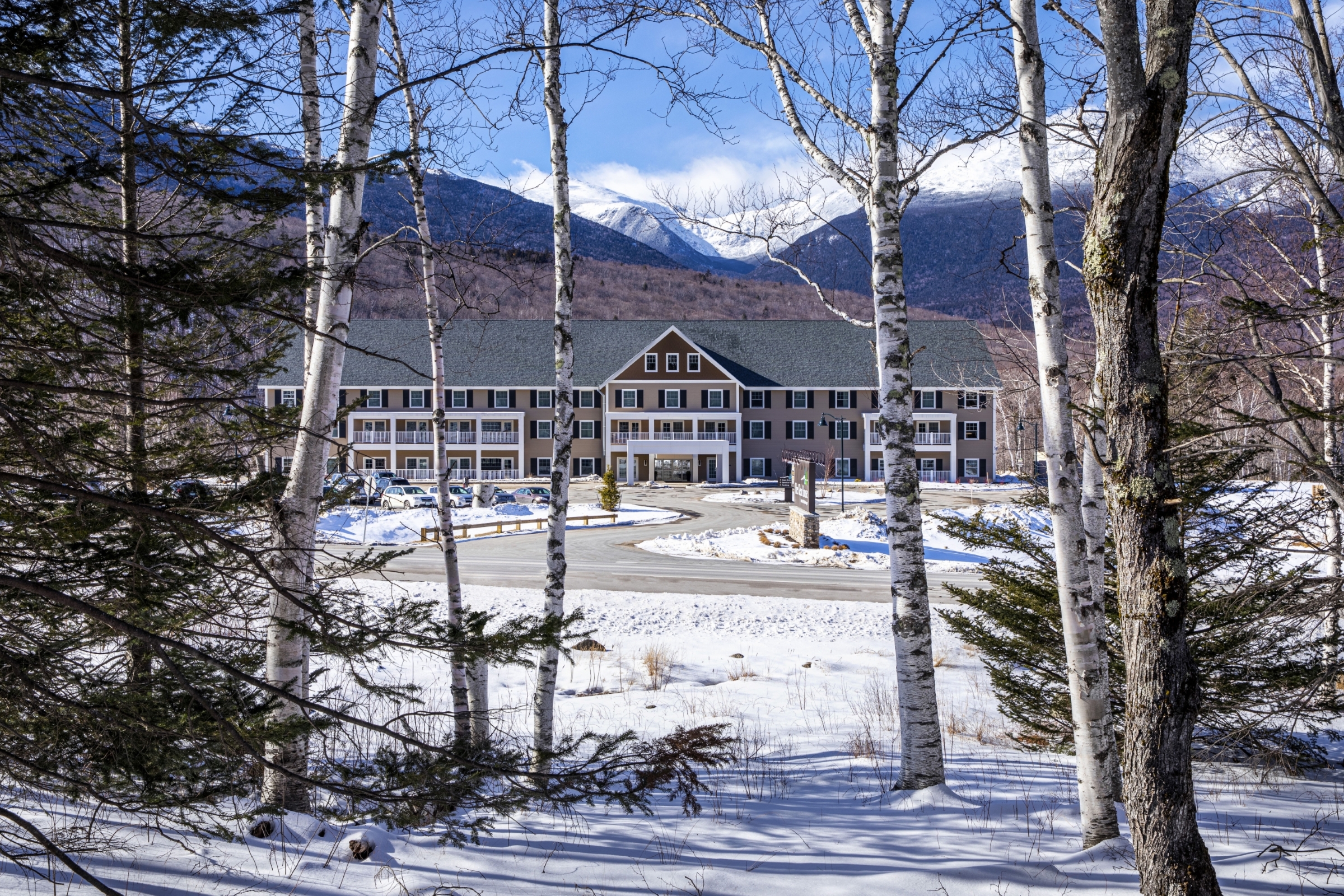 Glen House between trees during winter