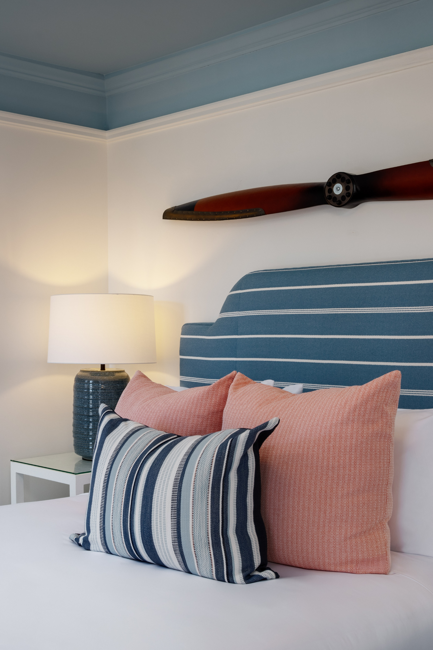 Queen guest room at 76 Main Ink Press Hotel with a propeller decoration above the headboard